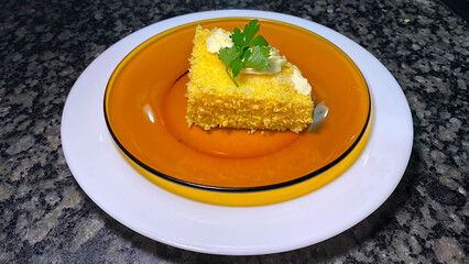 Delicious couscous with butter and a parsley leaf to garnish the dish.