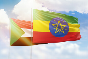 Sunny blue sky and flags of ethiopia and sudan