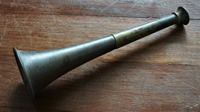 antique brass ships horn on wooden background