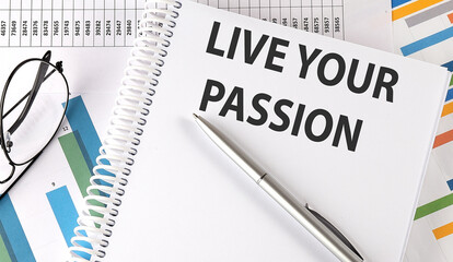 LIVE YOUR PASSION text , pen and glasses on the chart,business