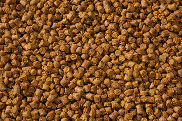 Colorful food for aquarium fish, granules and tablets from natural ingredients, close-up texture, animal food