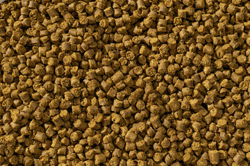 Colorful food for aquarium fish, granules and tablets from natural ingredients, close-up texture, animal food