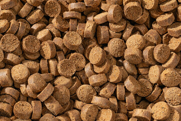 Colorful food for aquarium fish, granules and tablets from natural ingredients, close-up texture, animal food