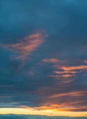 Fantastic thunderclouds at sunrise, vertical panorama