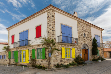 Old house with colorful window shutters in Alacati, Izmir, Turkey