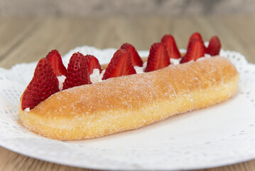 Tempting fresh from the oven fresh strawberry suguar donut from the bakery served on a plate