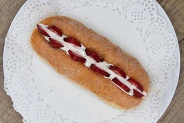 Overhead view of tempting fresh from the oven fresh strawberry suguar donut from the bakery served on a plate