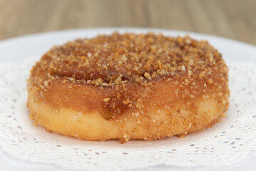 Tempting fresh from the oven cinnamon roll crumb cake donut from the bakery served on a plate