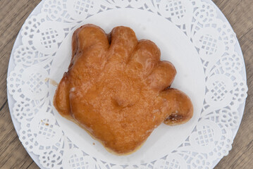 Overhead view of tempting fresh from the oven bear claw donut from the bakery served on a plate