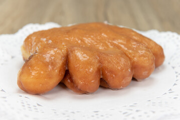 Tempting fresh from the oven bear claw donut from the bakery served on a plate