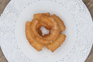 Overhead view of tempting fresh from the oven old fashioned donut from the bakery served on a plate