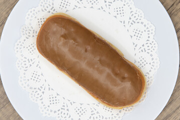 Overhead view of tempting fresh from the oven maple bar donut from the bakery served on a plate