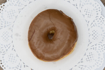 Overhead view of tempting fresh from the oven maple donut from the bakery served on a plate