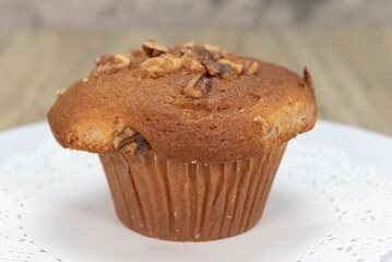 Tempting fresh from the oven banana nut muffin from the bakery served on a plate
