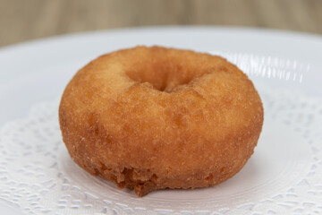 Tempting fresh from the oven plain donut from the bakery served on a plate