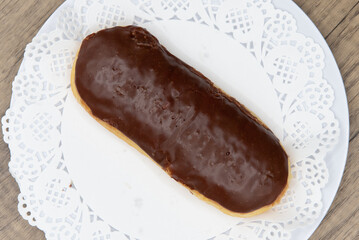 Overhead view of tempting fresh from the oven chocolate bar donut from the bakery served on a plate
