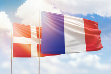 Sunny blue sky and flags of france and denmark