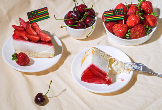 Juneteenth Day Picnic Background With Black Liberation African American Flags, Sweet Salad With Cherries And Strawberries, Strawberry Cheesecake