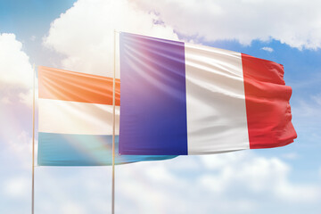 Sunny blue sky and flags of france and luxembourg - obrazy, fototapety, plakaty