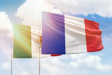 Sunny blue sky and flags of france and mexico