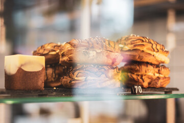 Creamy cakes in cafe showcase with price. Fresh pastry in cakestand. Sweet cakes and pie in cake stand. Delicious bakery. Sweet cake ready-to-eat. Gourmet dessert in restaurant.