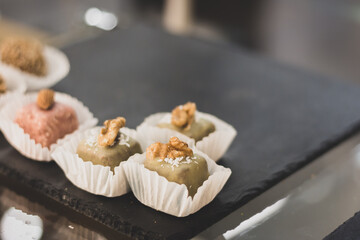 Sweet cupcakes decorated with nut. Cakes in cafe showcase. Fresh pastry in cakestand. Sweet dessert in cake stand. Delicious bakery. Sweet cake ready-to-eat. Gourmet dessert in restaurant.