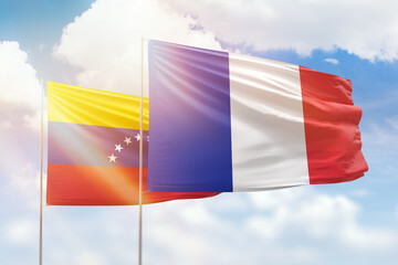 Sunny blue sky and flags of france and venezuela