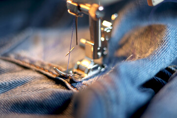 Broken needle in a sewing machine. The needle broke while sewing thick fabrics on the sewing...