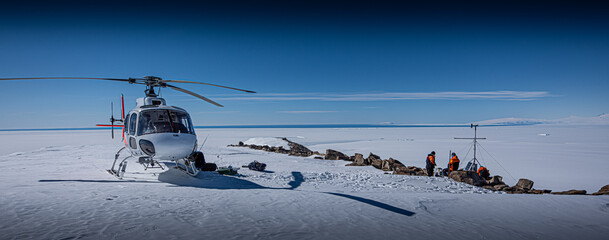 Scientists install experiments in dry valleys, Antarctica, via helicopter