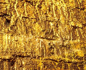 Stone texture. Structure. Shimmering surface. Precious Foil. Rough structure mineral. Rock texture. Gold texture. Golden Ore rocks. Stone background. Abstract texture. Rock pile.