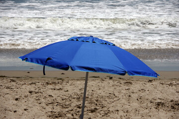 Blue umbrella at the ocean beach