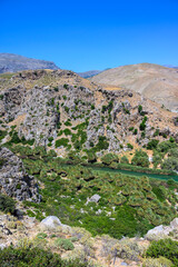 Preveli Beach - famous for the beautiful river with azure clear water and tropical palm forest behind the beach  - in southern Crete island, Greece, Europe.