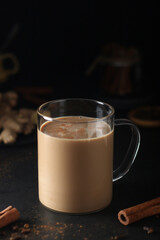 A cup with masala chai in low key