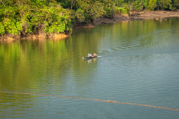 San Carlos, Antioquia, Colombia. November 11, 2020. People fishing the river by canoe