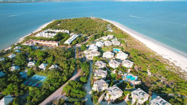 Panorama of Sanibel island in Lee County FL. Florida beach. Lighthouse. Spring or Summer vacations in USA. Blue-turquoise color of salt water. Ocean or Gulf of Mexico. Tropical Nature. Aerial view.