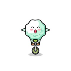 The cute chewing gum character is riding a circus bike