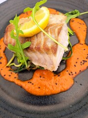Fillet of Pollock with red pepper sauce
