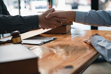 lawyer or judge shaking hands after agreeing to accept a bribe From businessman to lawsuit to win legal, illegal bribery, bribery and corruption concept.