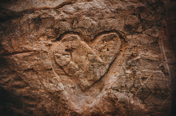 romantic message in the form of a heart carved into sandstone