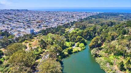 San Francisco Golden Gate Park aerial over pond by city edge