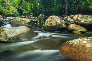 Naklejka na ściany i meble Photo of water flowing between rocks, Mountala river, Aceh, Indonesia.