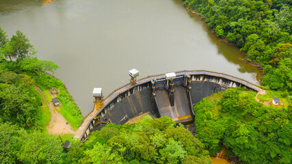 Water dam and reservoir lake, generating hydro electricity power renewable energy. Sri Lanka.