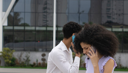 white curly brazilian woman empowered executive calling on cell phone