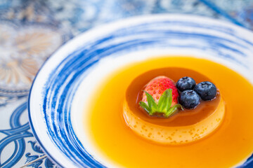 pudding caramel custard with strawberry and blueberry