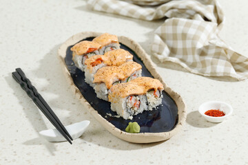 Japanese Food Salmon Mentai Sushi Roll with Crab Stick on Long Blue Oval Plate.