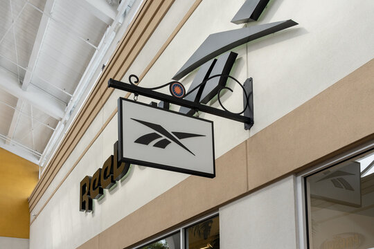 Orlando, Florida, USA - January 21, 2022:  Reebok store hanging sign is seen in Orlando, Florida, US. Reebok International Limited is a British-American fitness footwear and clothing manufacturer. 
