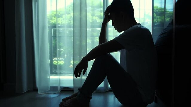 man sitting in the corner of the room have emotional and mental problems He has depression and stress from society and work. medical concept