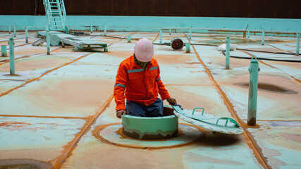 Male worker inside the pontoon tank storage visual inspection tank into the confined space