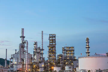 Twilight scene of oil refinery plant and storage white tank oil of Petrochemistry