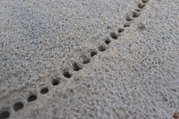 water droplets form a hole in the fine sand. natural background